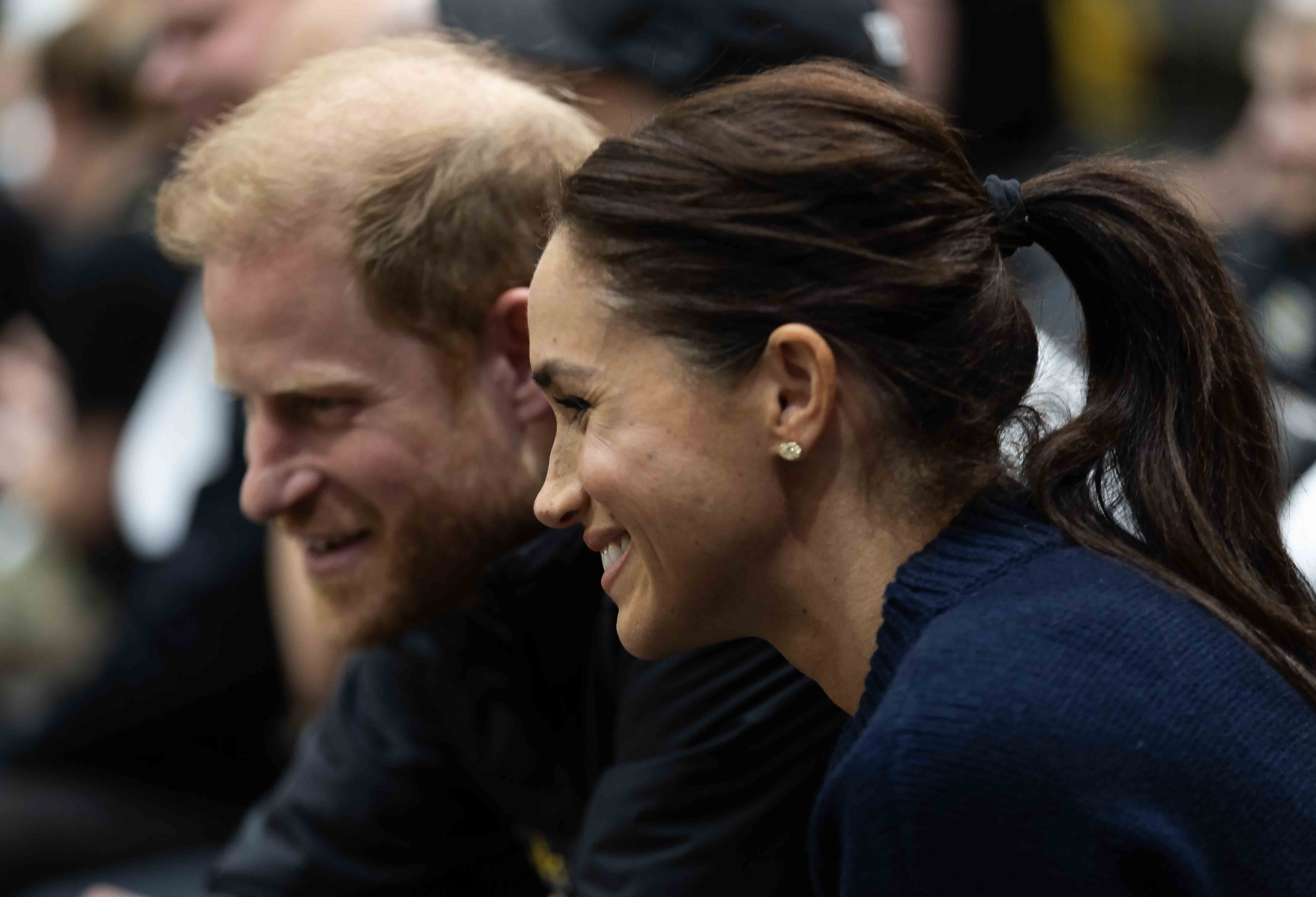 Meghan and Harry at courtside.