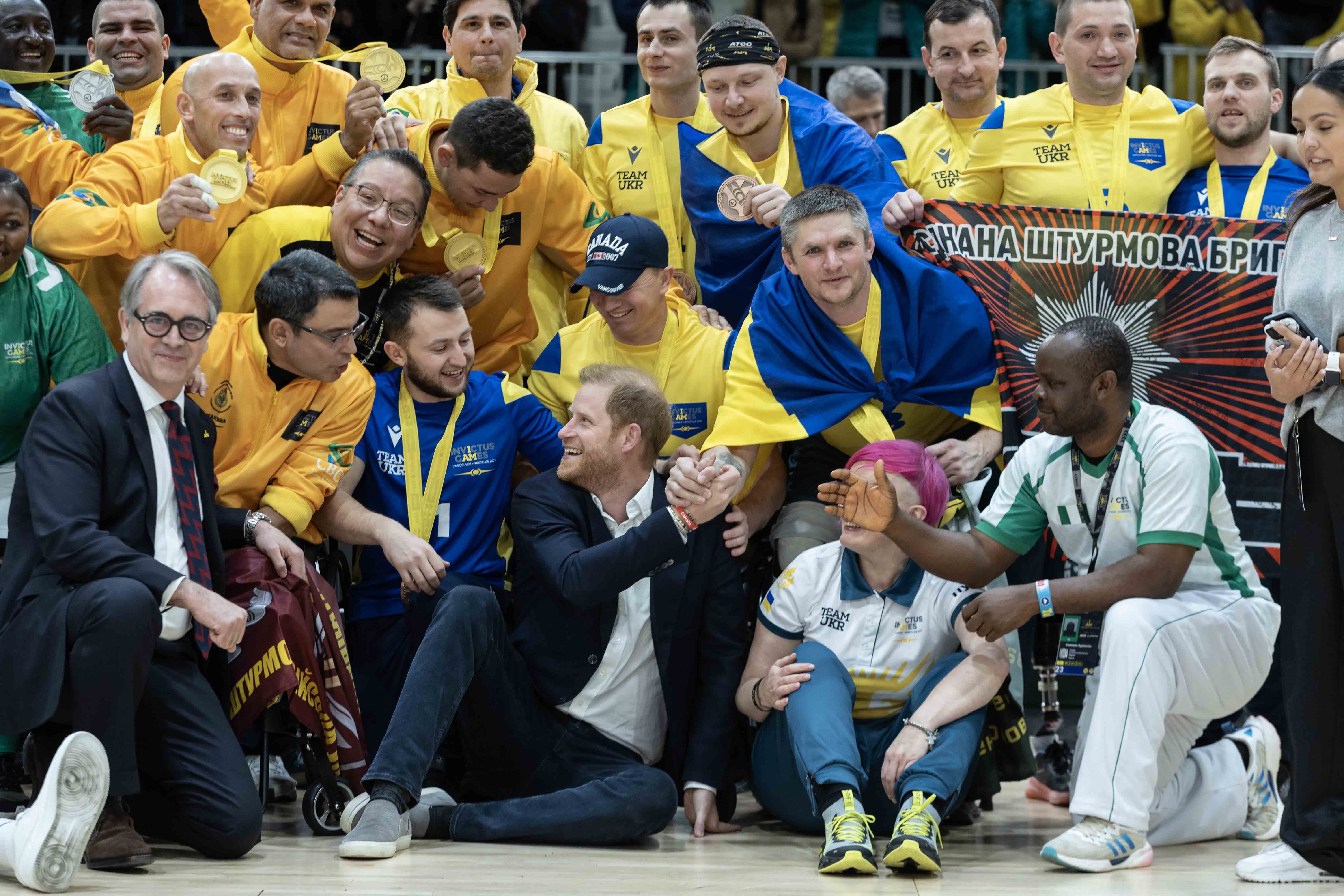 Prince Harry spent more time with athletes at these Games than he did in Toronto. Here, he sits with Brazilian, Nigerian and Ukrainian seated volleyballers.