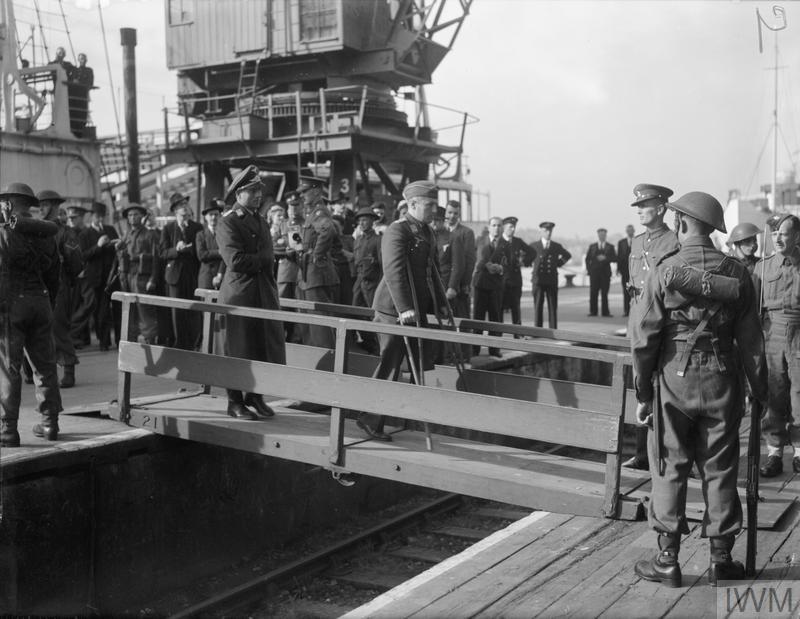 
A wounded German prisoner, a walking case, coming ashore from the hospital ship. 