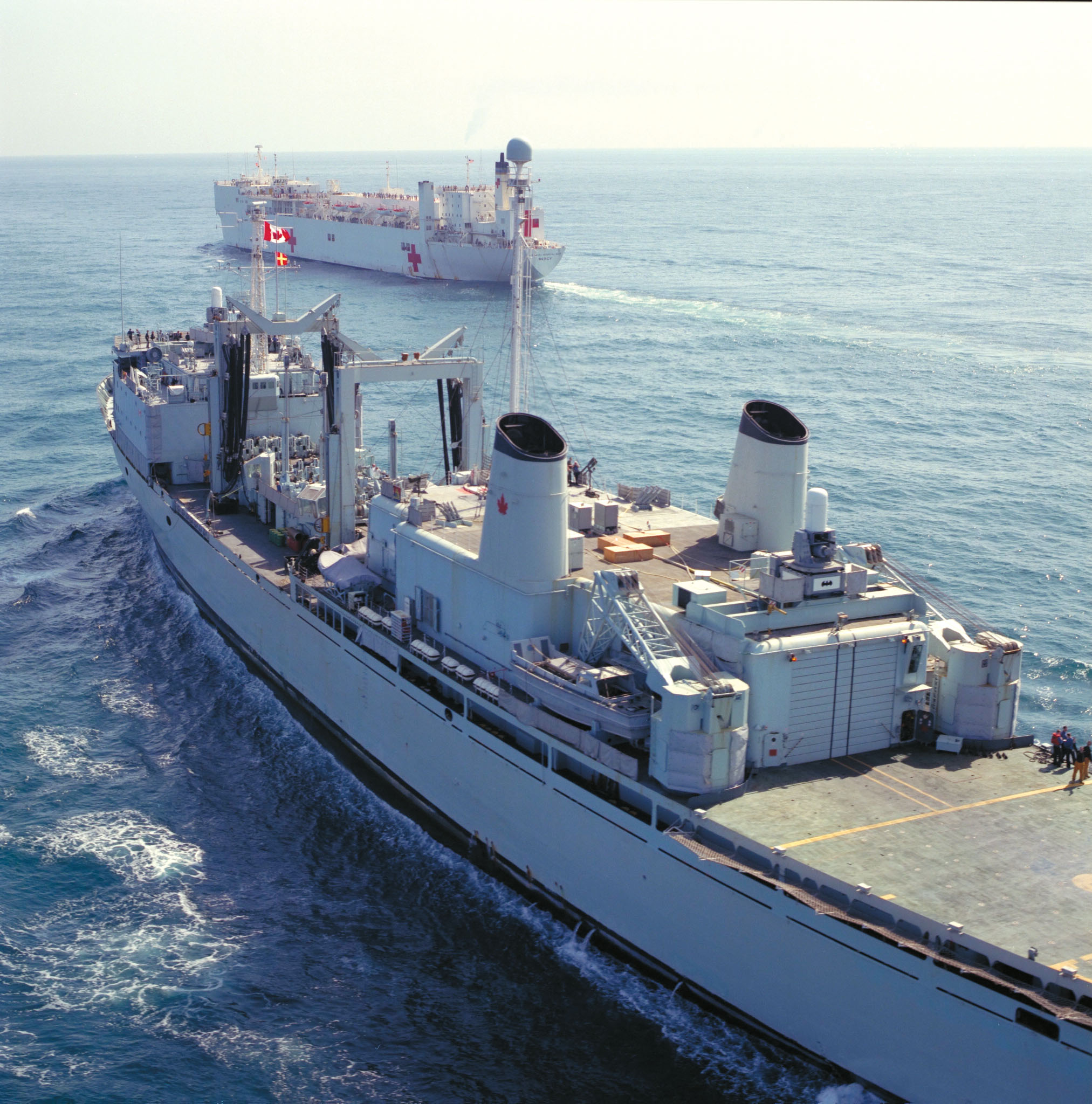 View of HMCS Protecteur and HMC Mercy at sea.