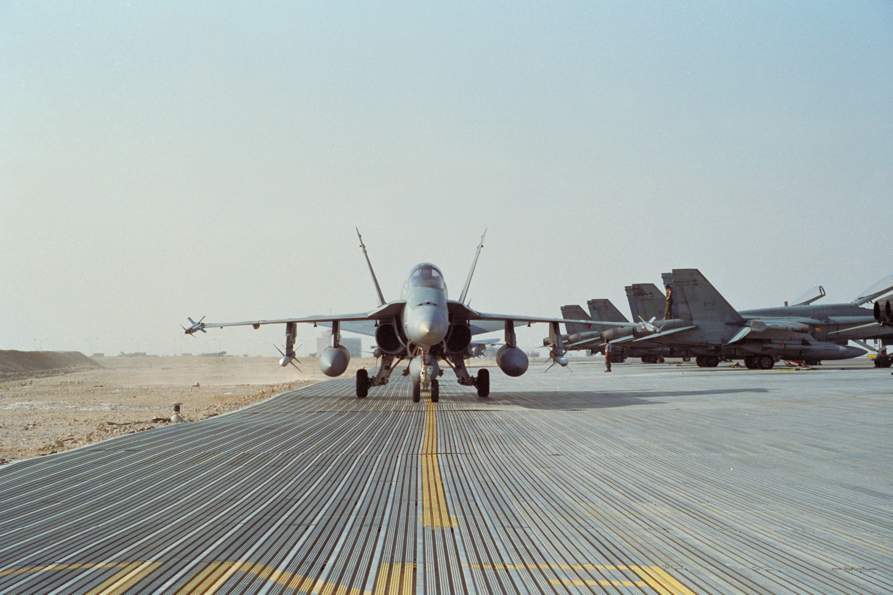 A CF-18 taxis into line after completion of a combat air patrol.