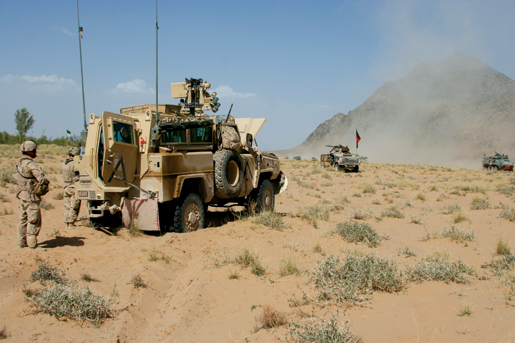 The OMLT Nyala sits broken down in the desert. [PHOTO: ADAM DAY]