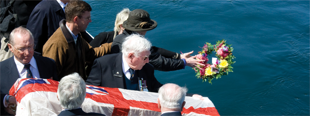 A burial board covered with the White Ensign is used to commit a sailor's ashes to sea on board HMCS Sackville. [PHOTO: DAN BLACK]
