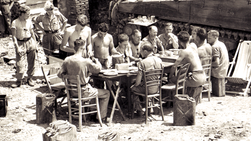 Members of the Ontario Regt. dine in Italy, June 1944. [PHOTO: BARRY G. GILROY, LIBRARY AND ARCHIVES CANADA—PA145776]