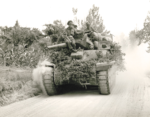 A Canadian tank on the move near Montevarchi, Italy, July 1944. [PHOTO: LIBRARY AND ARCHIVES CANADA—PA160454]