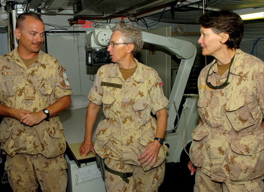 At the multinational, Canadian-led hospital at Kandahar Airfield in Afghanistan, technician Sgt. Dave Mann (left) discusses equipment with then-Commodore Margaret Kavanagh and Dr. Ruth Collins-Nakai, then president of the Canadian Medical Association.[PHOTO: CPL. ROBIN MUGRIDGE, TASK FORCE AFGHANISTAN, ROTO 1 IMAGERY TECHNICIAN]
