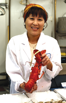 Cathy Konkel sells seafood for Domenic’s in the market. [PHOTO: ST. LAWRENCE MARKET]
