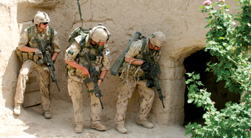 Troops stack up near the door for a compound-clearing operation. [PHOTO: ADAM DAY]