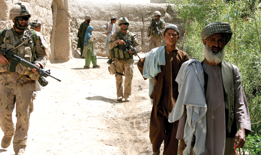 Villagers and Bravo Company soldiers walk together near Haji. [PHOTO: ADAM DAY]