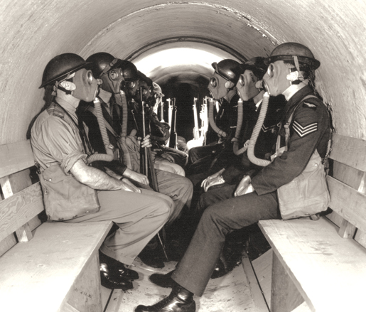 Personnel occupy an air raid shelter at Patricia Bay, B.C. [PHOTO: CANADIAN FORCES—PL9605]