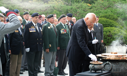 Veterans Affairs Minister Greg Thompson takes a pinch of incense at the Republic of Korea National Cemetery in Seoul. [PHOTO: TOM MACGREGOR]