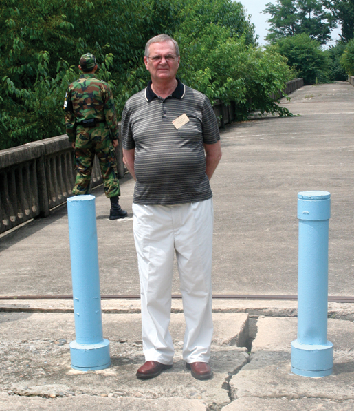 Former prisoner of war Jim Gunn stands on “the bridge of no return”. [PHOTO: TOM MACGREGOR]