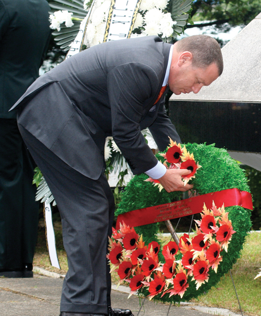 Ambassador Ted Lipman places a wreath. [PHOTO: TOM MACGREGOR]
