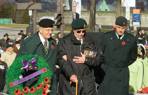 Georges Lasnier assists Charly Forbes in placing a wreath. [PHOTO: TOM MacGREGOR]