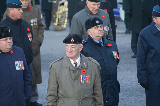 Joe Bilocq leads veterans in the parade. [PHOTO: TOM MacGREGOR]