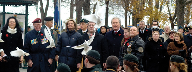 White doves held by (from left) Josée Verner, Mayor Régis Labeaume and Premier Jean Charest are released. [PHOTO: TOM MacGREGOR]