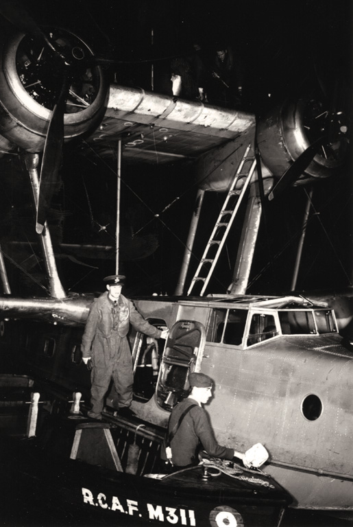 A boat is used to refuel a Stranraer flying boat near Bella Bella. [PHOTO: CANADIAN FORCES—PL9578]