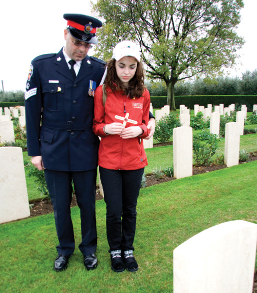 Police Staff Sergeant Nick Lisi and daughter Victoria say a few words at the grave of Pte. Emile Comeau. [PHOTO: DAN BLACK]