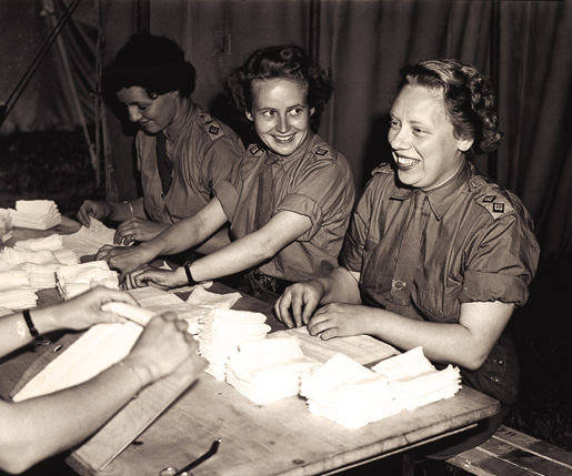 Nursing sisters of the Royal Canadian Army Medical Corps wrap bandages at a British hospital in Normandy, July 17, 1944. [PHOTO: LT. FRANK L. DUBERVILL, LIBRARY AND ARCHIVES CANADA–PA190096]