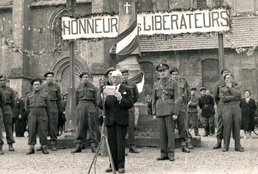 A speech is made during wartime liberation ceremonies. [PHOTO: CANADIAN ARMY]