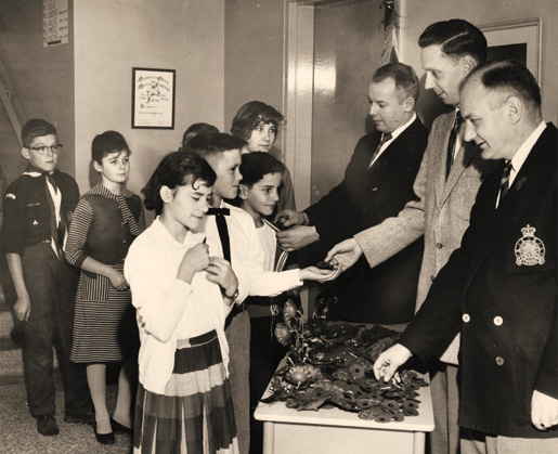 Legionnaires, in what was then Fort William, Ont., distribute poppies to schoolchildren in 1960. [PHOTO: LEGION MAGAZINE ARCHIVES]