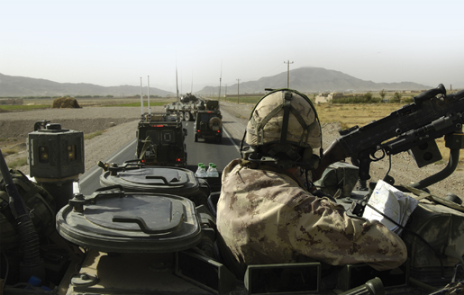 Canadian soldiers halt traffic west of Kandahar in order  to check for improvised explosive devices. [PHOTO: MASTER CORPORAL ROBERT BOTTRILL, CANADIAN FORCES COMBAT CAMERA]