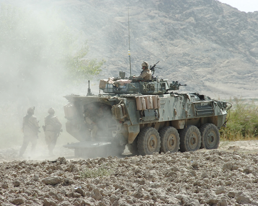 A LAV III provides perimeter security for soldiers on patrol. [PHOTO: SERGEANT LOU PENNEY, CANADIAN FORCES]