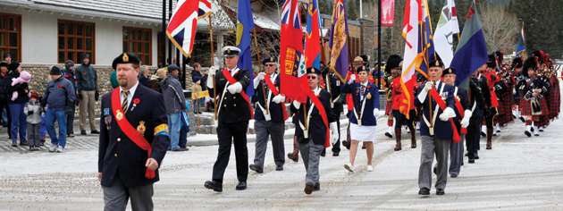 Misty and snowy mountains are the backdrop for the Banff, Alta., Remembrance Day parade. [PHOTO: ADAM DAY]