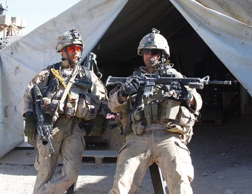 Corporal John Little (left) and another 1st Platoon member wait for a patrol to kick off. [PHOTO: ADAM DAY]
