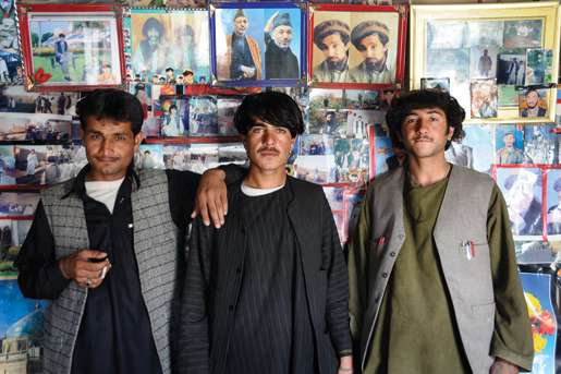 Young members of the Afghan Border Police stand in front of portraits of Ahmad Shah Massoud and Afghanistan President Hamid Karzai. [PHOTO: MATTHIEU AIKINS]