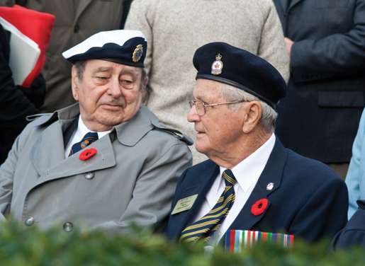 Veterans Dusty Miller and Roland Demers chat before a ceremony begins. [PHOTO: TOM MacGREGOR]