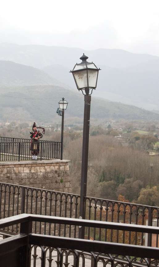 Piper Sergeant William MacDougall plays from the walls of Pontecorvo overlooking the Liri Valley. [PHOTO: TOM MacGREGOR]