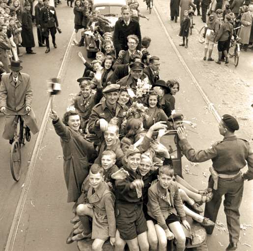 Joyful Dutch civilians and Canadian soldiers celebrate the liberation of Utrecht, May 7, 1945. [PHOTO: ALEXANDER STIRTON, LIBRARY AND ARCHIVES CANADA—PA140417]