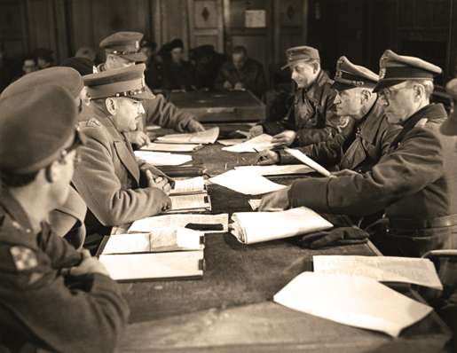 Lt.-Gen. Charles Foulkes (left centre) accepts the surrender of German forces in the Netherlands, May 5, 1945. [PHOTO: ERNEST J. DeGUIRE, LIBRARY AND ARCHIVES CANADA—PA134408]