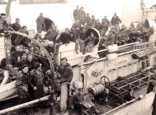 Survivors of a torpedoed merchant ship aboard HMCS Arvida at St. John’s, September 1942. [PHOTO: GERALD M. MOSES, LIBRARY AND ARCHIVES—PA136285]