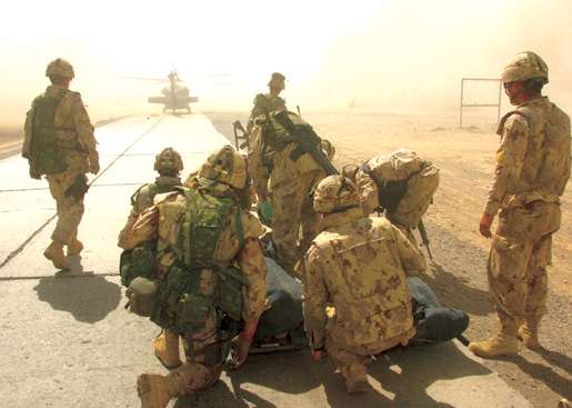 Canadian soldiers evacuate wounded in Afghanistan, 2006. [PHOTO: COMBAT CAMERA]