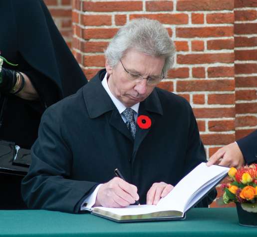Veterans Affairs Minister Jean-Pierre Blackburn signs the guest book at Groesbeek. [PHOTO: TOM MacGREGOR]