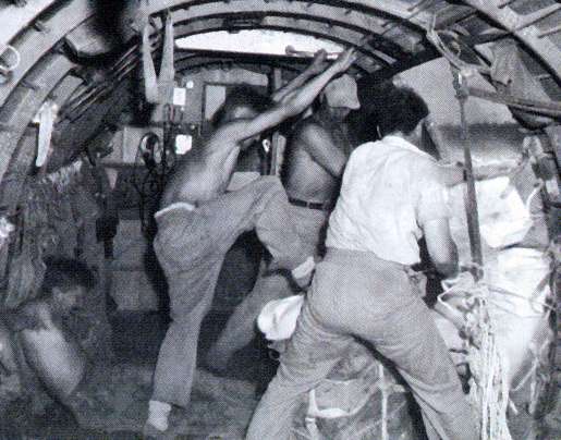 Crew in another RCAF C-47 Dakota kick supplies out over Burma in 1945. [PHOTO: ROYAL CANADIAN AIR FORCE PL60727]