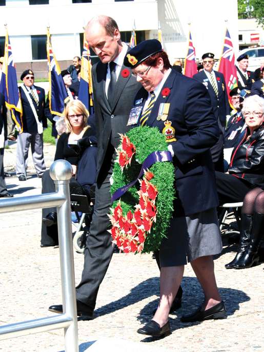 Wim Geerts, Ambassador of the Netherlands, assisted by Legion First Vice Pat Varga, prepares to place a wreath at the cenotaph. [PHOTO: JENNIFER MORSE]