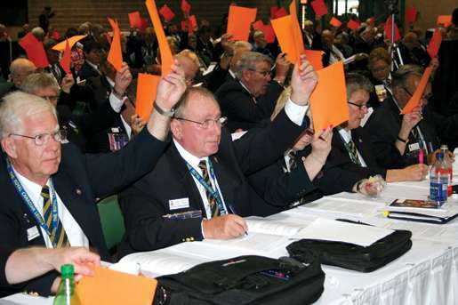 Delegates vote during business sessions. [PHOTO: JENNIFER MORSE]