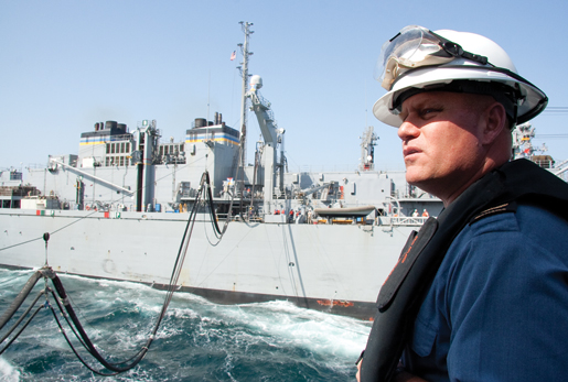 Fredericton’s Chief Bo’s’n Mate, Chief Petty Officer Gerry Ross, observes a fuel replenishment at sea. [PHOTO: DAN BLACK]