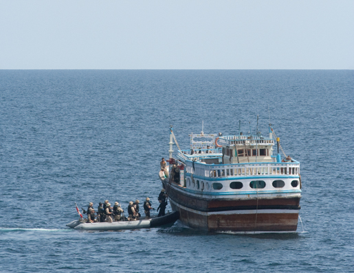 The naval boarding party investigates a dhow. [PHOTO: DAN BLACK]