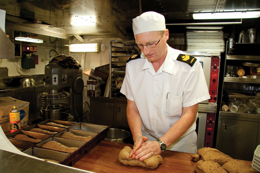 Petty Officer 2nd Class Keith O’Brien in the galley. [PHOTO: DAN BLACK]