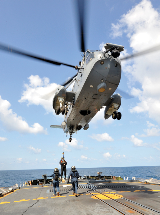 Lieutenant (N) Jennifer Gosse, padre on board HMCS Fredericton, is hoisted into a Sea King helicopter during an anti-piracy mission in the Gulf of Aden in January 2010. [PHOTO: CANADIAN FORCES]