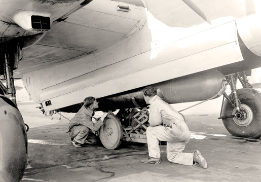 Ground crew load  a torpedo into an aircraft at Patricia Bay, B.C. [PHOTO: LIBRARY AND ARCHIVES CANADA—PA144773]