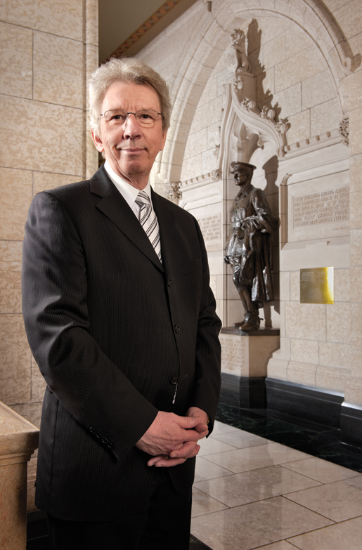 Veterans Affairs Minister Jean-Pierre Blackburn in the lobby outside the House of Commons. Behind him is the statue of Lieutenant-Colonel George Harold Baker, the first and only member of Parliament killed in action during the First World War. [PHOTO: METROPOLIS STUDIO]