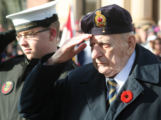 Veteran John Thistle salutes at the cenotaph. [PHOTO: TOM MacGREGOR]