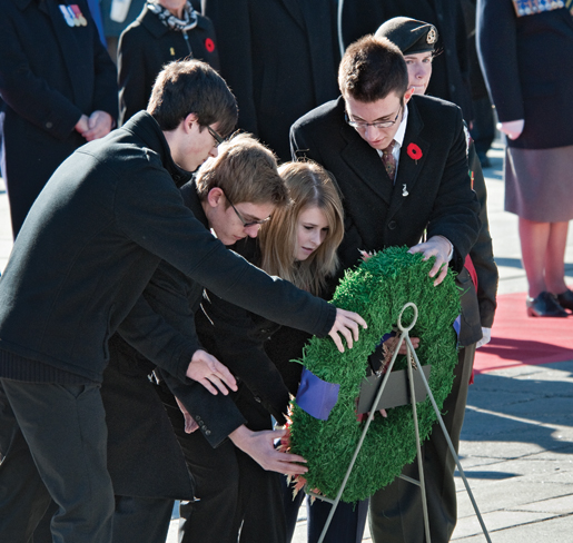 Senior winners of the Legion literary and poster contest place a wreath. [PHOTO: METROPOLIS STUDIO]