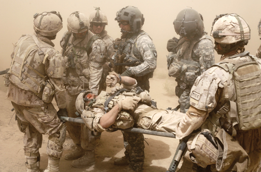 Master Corporal Ken Wilson and the American medevac team that rescued him. [PHOTO: ADAM DAY]