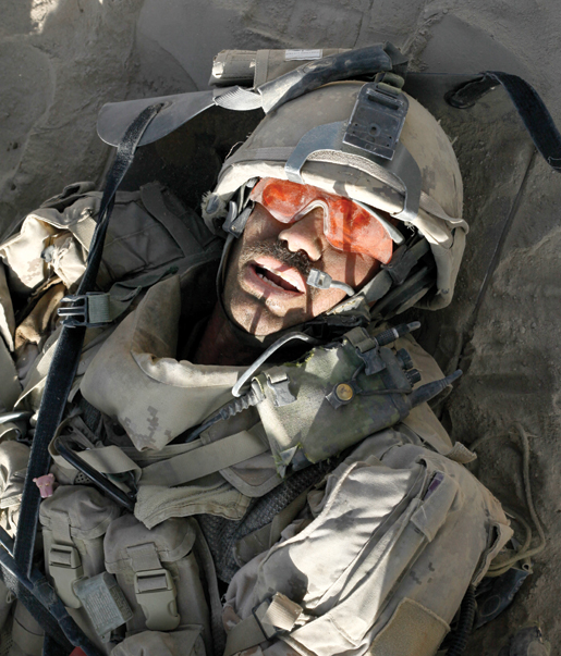 Master Corporal Ken Wilson  on a stretcher, a few minutes after being wounded. [PHOTO: ADAM DAY]
